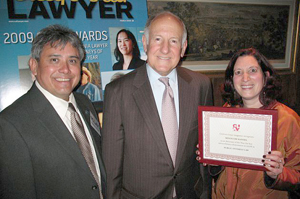 Minouche Kandel, right, holds up her attorney of the year award from the California Lawyer magazine. With her are Ramon Arias, executive director of Bay Area Legal Aid, left, and Ronald M. George, Chief Justice of the California Supreme Court.