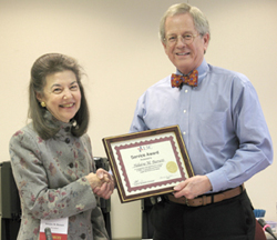 LSC President Helaine M. Barnett receives her five-year service award from LSC Board Chairman Frank B. Strickland.