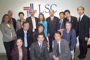 LSC President Helaine M. Barnett (back row, center), and LSC's Treefa Aziz and John Constance (far left) stand with members of the Japan Federation of Bar Associations.