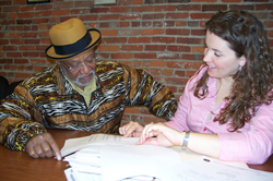 Katie Laskey-Donovan consults with a client who came to the Legal Aid Society of Cleveland's Wage Project for help.
