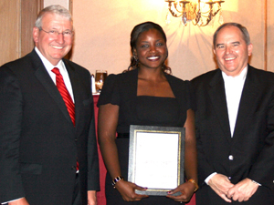 Wells, left, stands with Legal Services Alabama Employee of the Year Jaffe Pickett and state bar president Mark White.