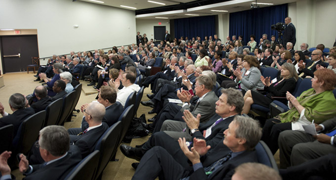 Audience members listen to a panel discussion.