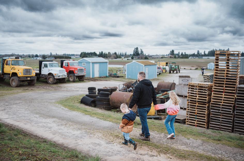 family walking through ranch with tractors