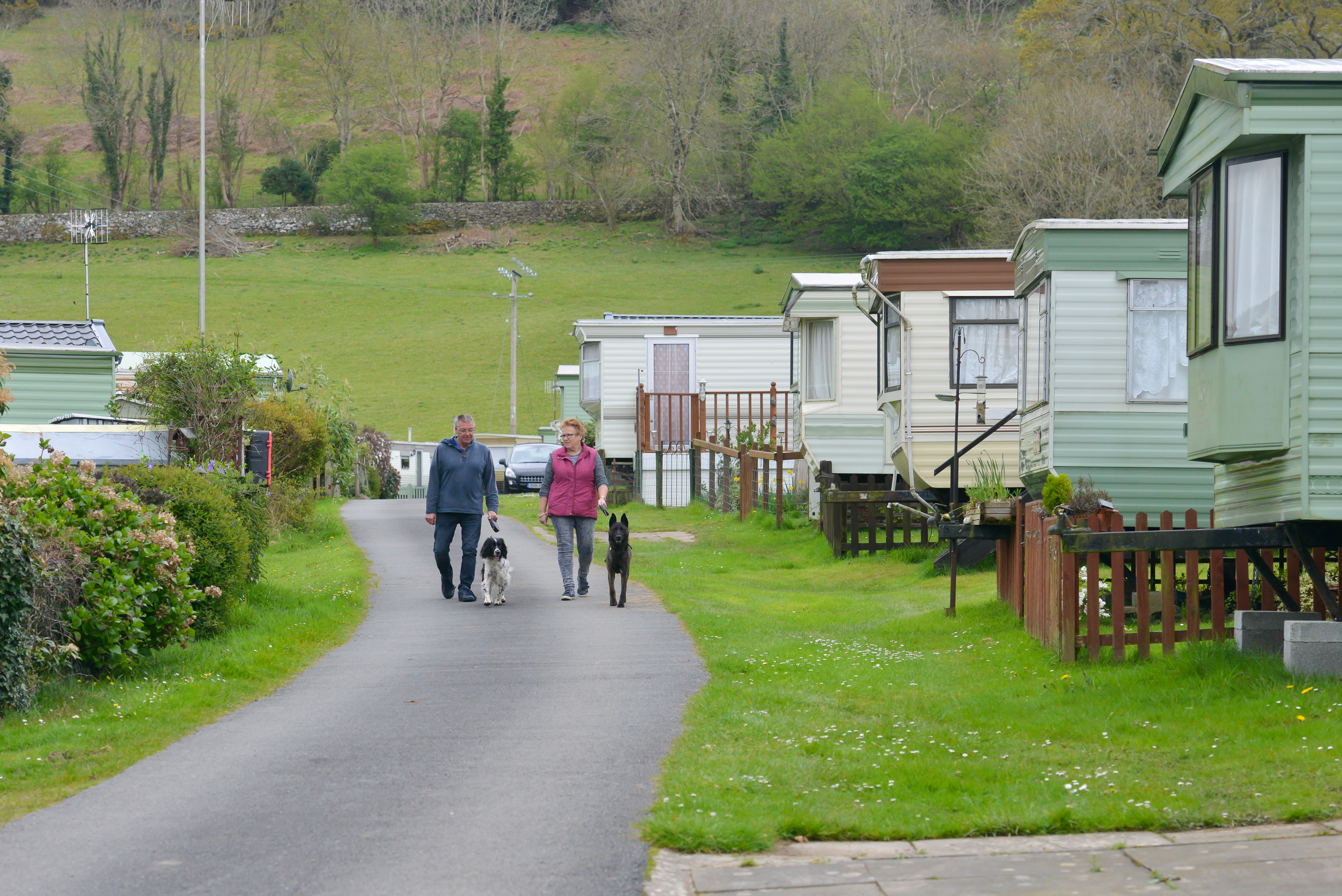 couple walking by mobile homes