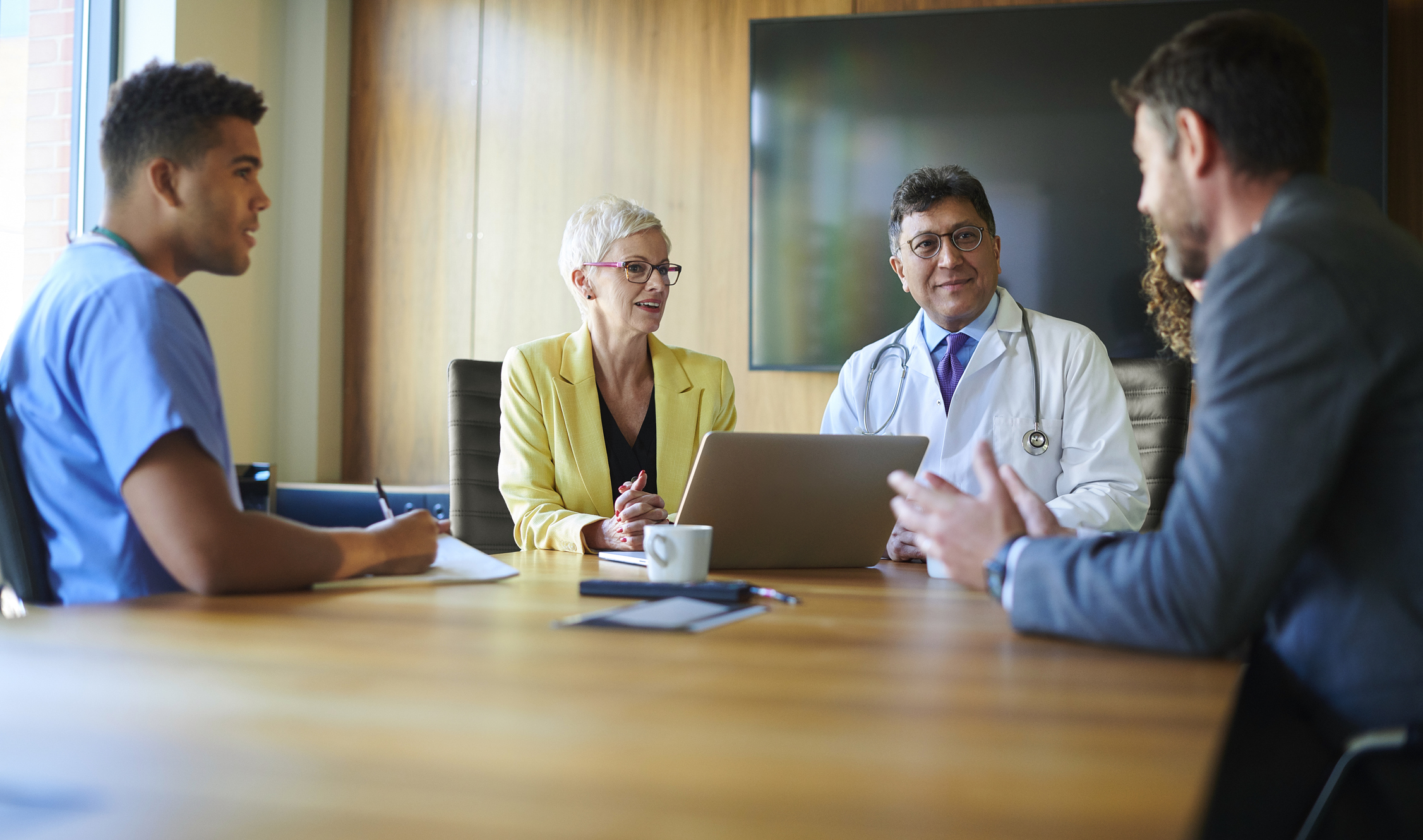 Doctors and lawyers speaking at a table.