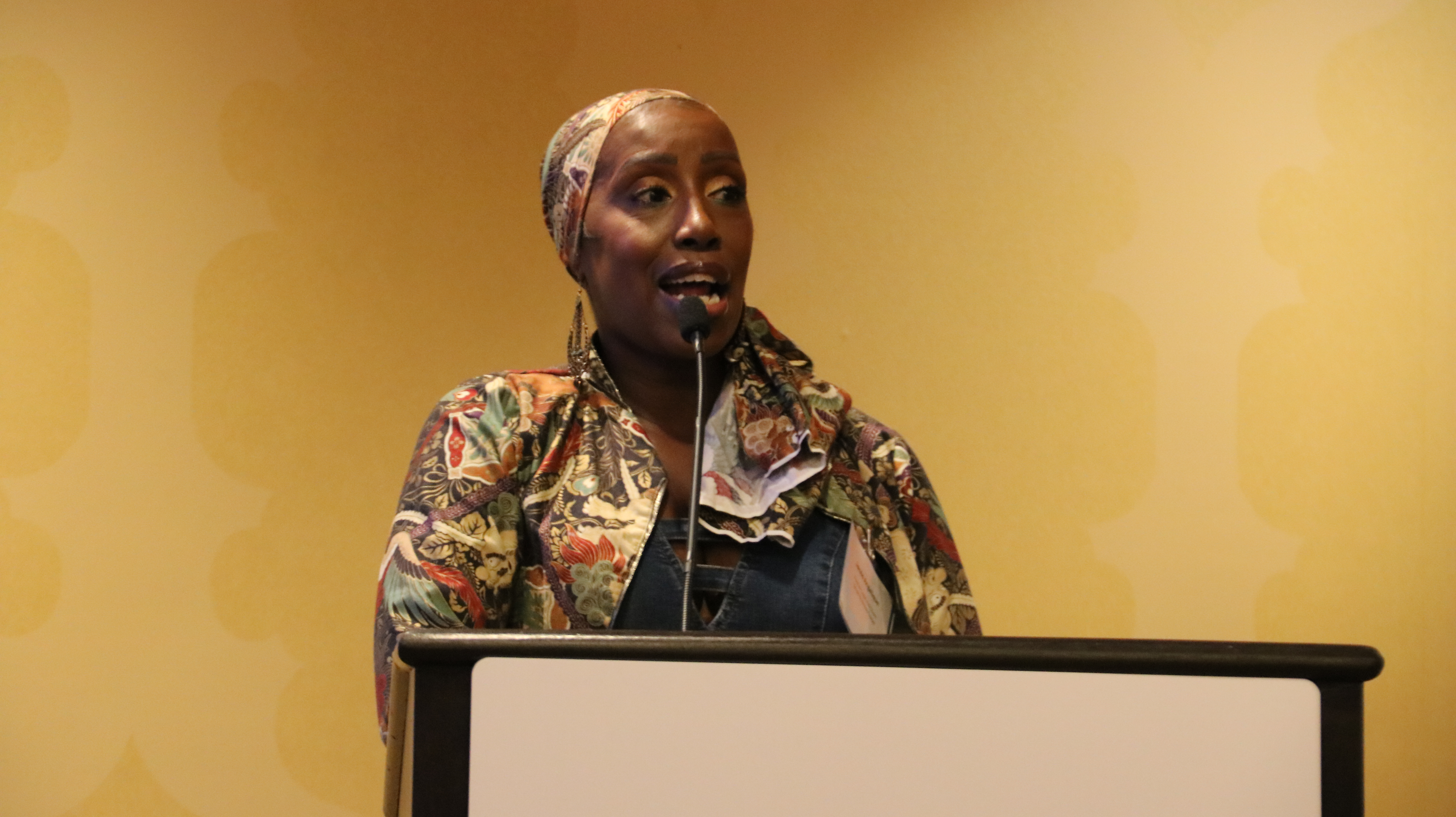 Woman standing at podium speaking