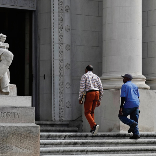 Two men walking up stairs into court house