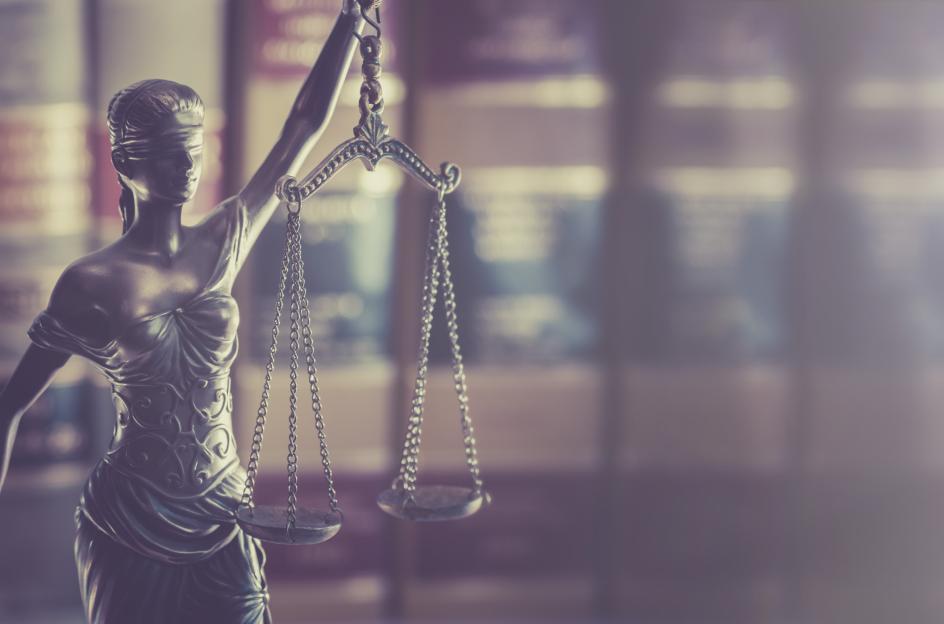 shutterstock_justice_holding_scales_with_law_books