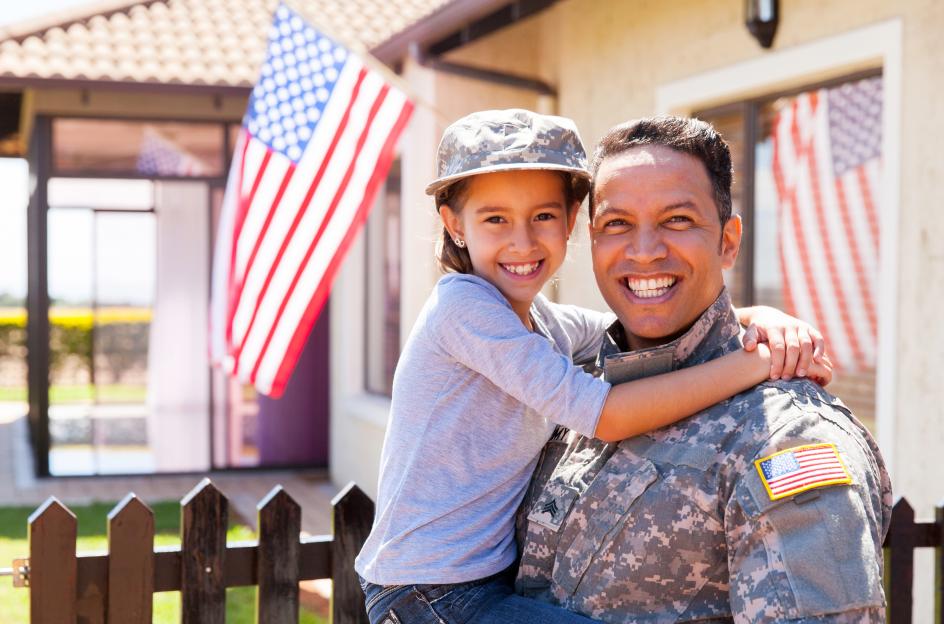 male veteran holding child