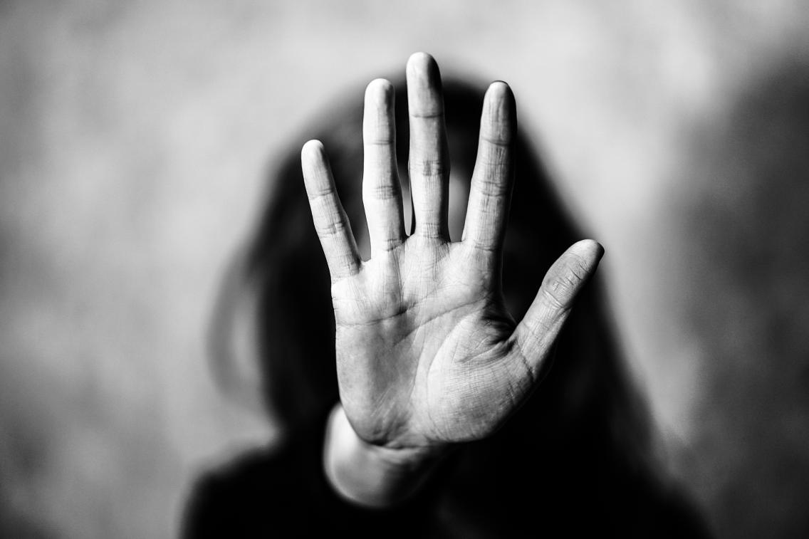 black and white image of woman with palm in camera