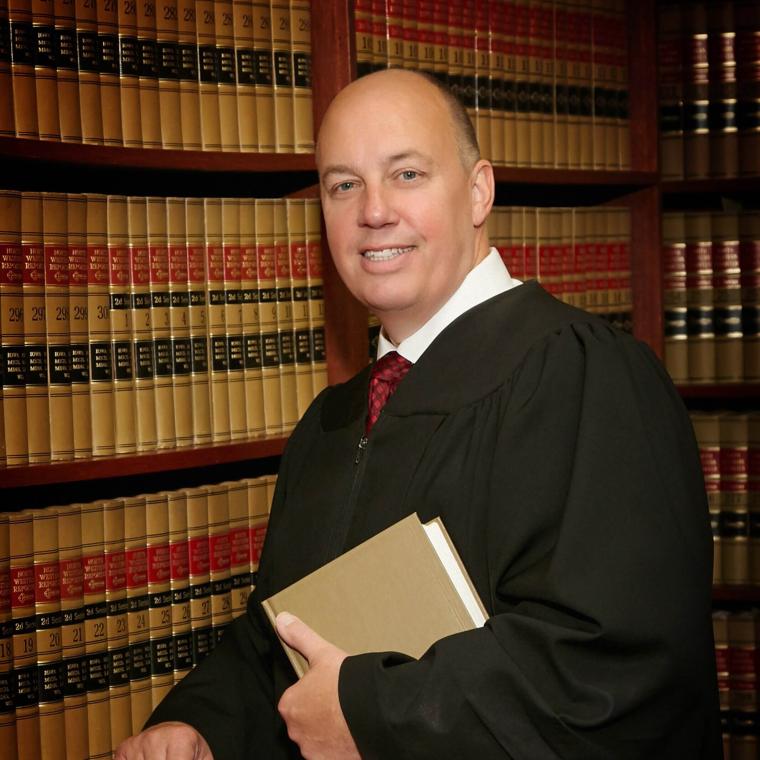 Chief Justice in robe smiling